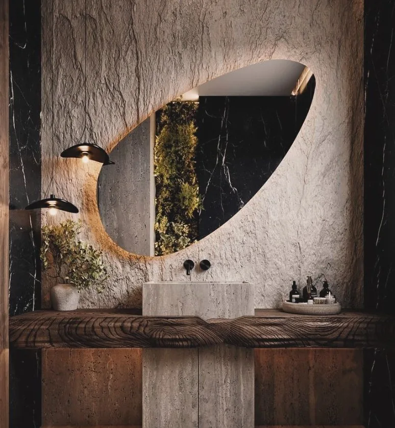 Lavabo com parede de pedra e vegetação